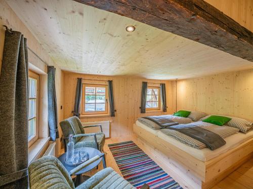 a room with two beds and chairs in a tiny house at Raneburg 4 in Matrei in Osttirol