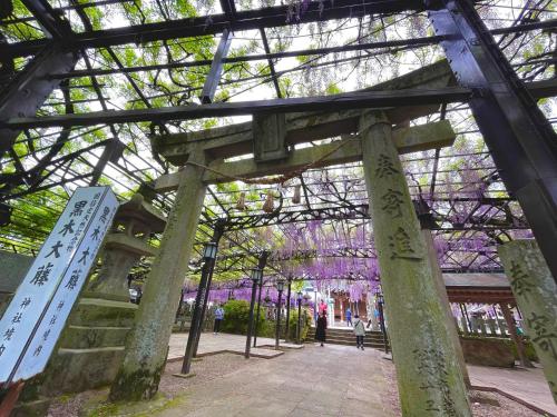 a structure with trees with purple flowers at ootaryokan in Kuroki