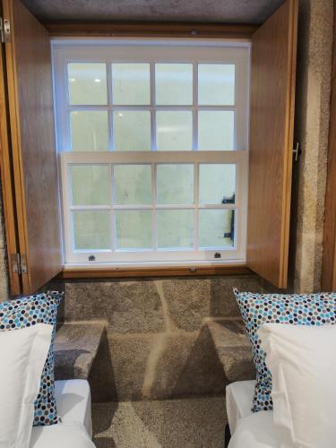 a window in a room with two chairs and a staircase at Belomont6 Apartments in Porto