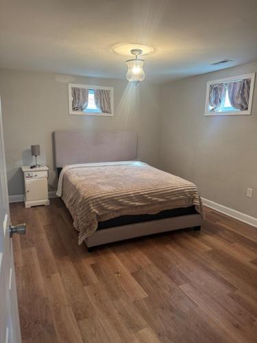 a bedroom with a bed and two windows at 2BR Spacious Escape Close to DC & Baltimore in Laurel