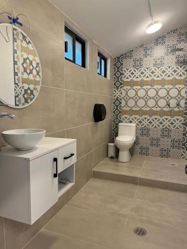 a bathroom with a sink and a toilet at Morada Luna Roma in Mexico City