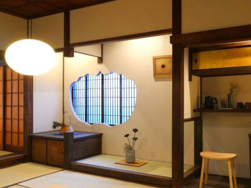 a room with a table and a mirror on the wall at NIPPONIA HOTEL Takehara Saltworks Town in Takekara