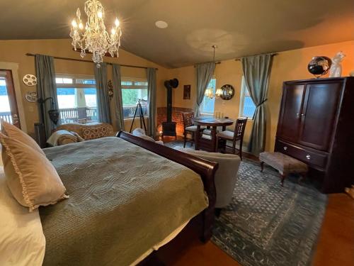 a bedroom with a bed and a dining room at The Tuwanek Bed and Breakfast in Sechelt