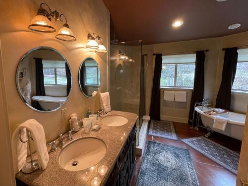 a bathroom with two sinks and a large mirror at The Tuwanek Bed and Breakfast in Sechelt