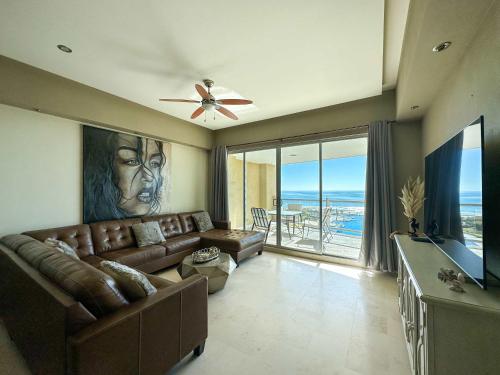 a living room with a couch and a large window at Beachfront Condo with Stunning Views Tranquil Stay in Puerto Peñasco