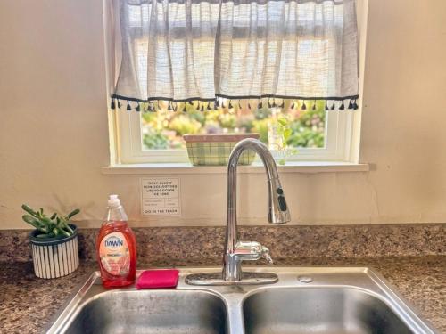 a kitchen sink with a detergent sitting next to a window at Lux Modern 3BR King Bed Smart TV PetFriendly in Killeen