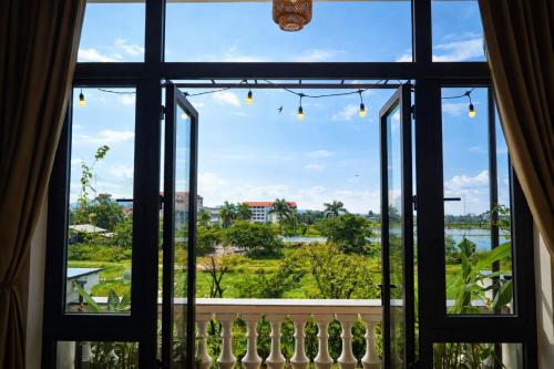 an open window with a view of the water at Pavillon D'Hue Homestay in Hue