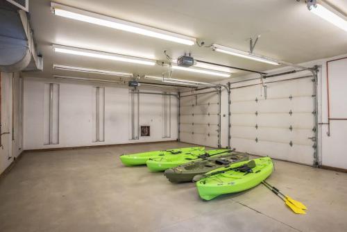 a row of kayaks lined up in a garage at Private Riverfront Estate with Kayaks & Views in Post Falls