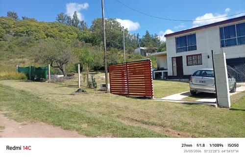 a car parked in front of a building with a gate at La casa de Anto in Tanti