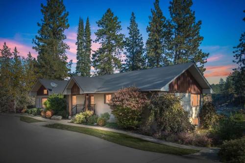 a home with a gambrel roof at Private Riverfront Estate with Kayaks & Views in Post Falls