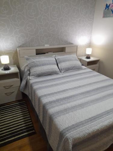 a bedroom with a large bed with two night stands at Loft Centro Cívico in San Juan