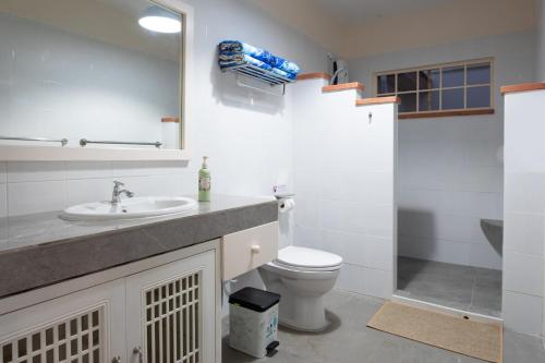 a bathroom with a sink and a toilet and a shower at The Hidden Lagoon in Rawai Beach