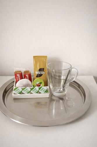 a glass plate with a glass cup and other items on it at Victoria House - Cozy Rooms in Edmonton