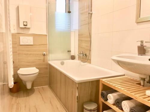 a white bathroom with a sink and a toilet at Ferienwohnung Modern 2 Rooms 4 Beds in Essen