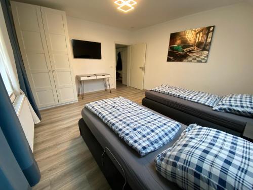 a living room with two beds and a table at Ferienwohnung Modern 2 Rooms 4 Beds in Essen