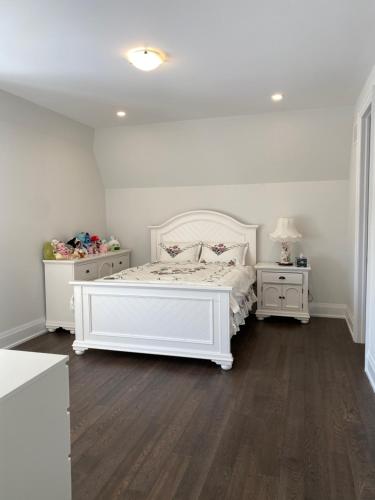 a bedroom with a white bed and two night stands at B-Willowdale Cummer Residence -Queen bedroom near Yonge-Finch in Toronto