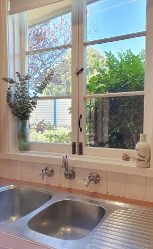 a kitchen sink in front of a window at Haven Cottage Kangaroo Island in Kingscote
