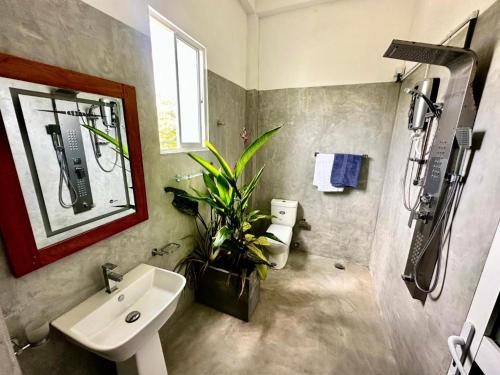 a bathroom with a sink and a shower at surf dom hotel & restaurants in Ahangama