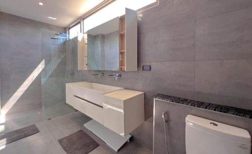 a bathroom with a sink and a toilet at Maerim Luxury 3BR Pool Villa with Mountain View in Ban Tai