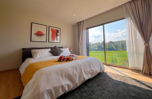 a bedroom with a bed with two stuffed animals on it at Maerim Luxury 3BR Pool Villa with Mountain View in Ban Tai