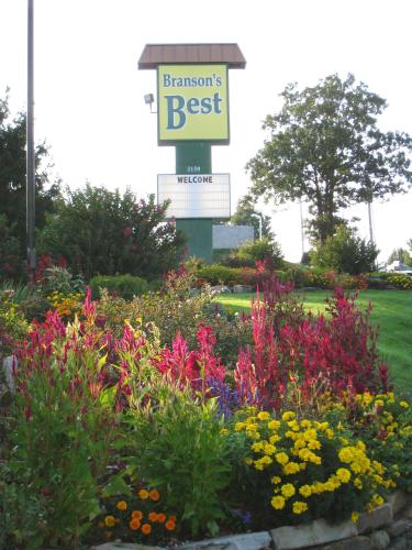 a flower garden with a sign for the best at Branson's Best in Branson