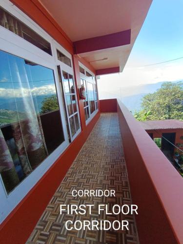 a balcony with a view of the mountains at Homestay in Darjeeling By NE DEN in Jāmb