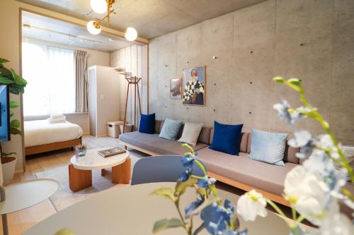 a living room with a couch and blue pillows at Ken's Place Minami-Azabu in Tokyo