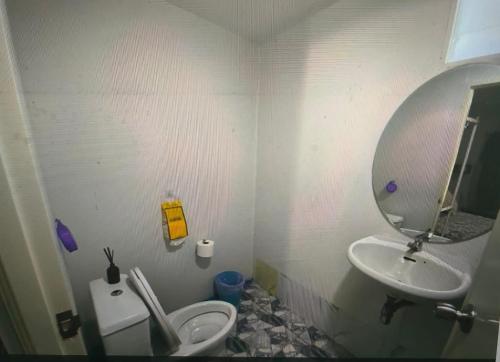 a bathroom with a sink and a toilet and a mirror at 3 Star and the Sun in Ban Nua