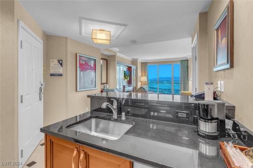 a kitchen with a sink and a counter top at The Signature MGM Condos in Las Vegas