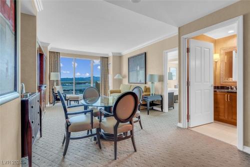 a living room with a table and chairs and a kitchen at The Signature MGM Condos in Las Vegas