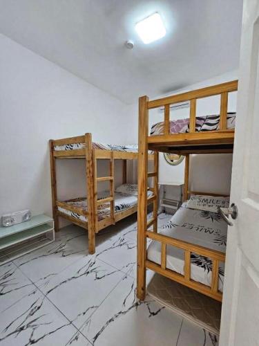 two bunk beds in a room with marble floors at View Deck Private Pool in De La Paz