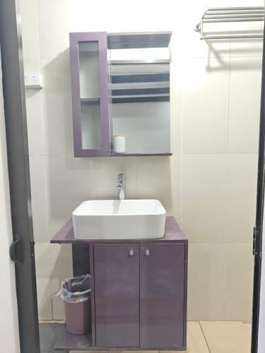 a bathroom with a sink and a mirror at 3 bedroom fully air conditioned family home -spacious, free parking in Suva