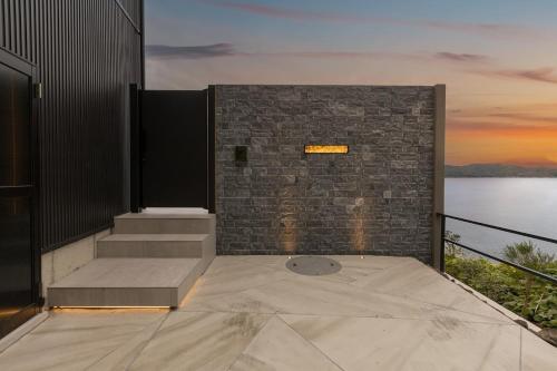 a balcony with stairs and a view of the water at Namioto Villa YOSA in Hama