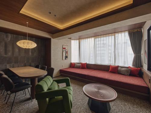 a living room with a couch and a table at illi Haku Asakusa in Tokyo