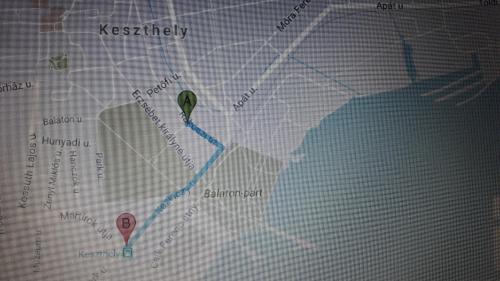 a close up of a map with a green marker at Dora Holiday House & Apartments in Keszthely