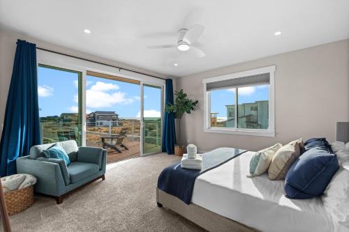 a bedroom with a bed and a chair and a window at The Oceanview Retreat in Westport