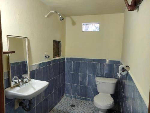 a bathroom with a toilet and a sink at koten Naj Cabanas in Xpujil
