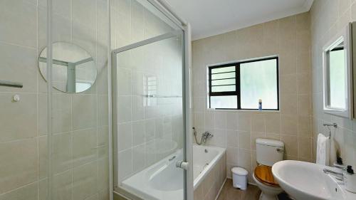 a bathroom with a shower and a toilet and a sink at The Dock in Clarens