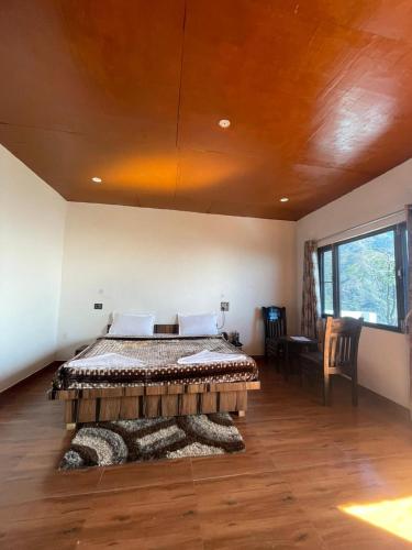 a bedroom with a bed in a room with a ceiling at ITW - Into The Wild , Viratkhai , Chakrata in Lakhwār