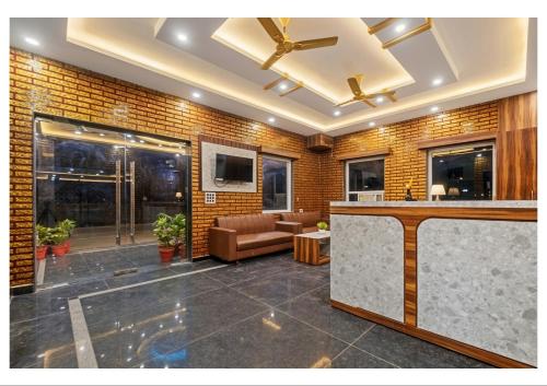 a lobby with a bar and a couch at RS Resort in Ayodhya