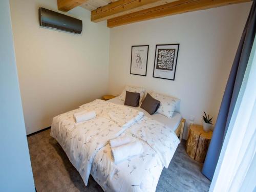a bedroom with a bed with a white comforter at Villa in Býšovec near Harusak Ski Resort in Ujčov