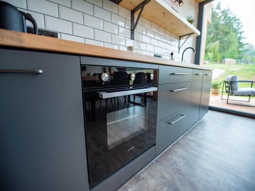 a kitchen with a counter with a stove top oven at Villa in Býšovec near Harusak Ski Resort in Ujčov