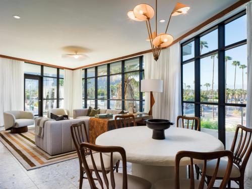 a living room with a table and chairs at Thompson Palm Springs, By Hyatt in Palm Springs