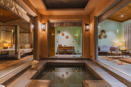 a house with a pool in the middle of a room at Brij Bageecha, Jaipur - IHCL SeleQtions in Jaipur