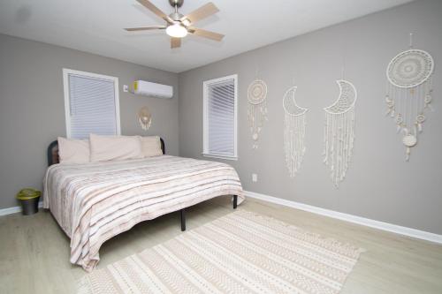 a bedroom with a bed and a ceiling fan at Home Sweet Home Bungalow in North Little Rock