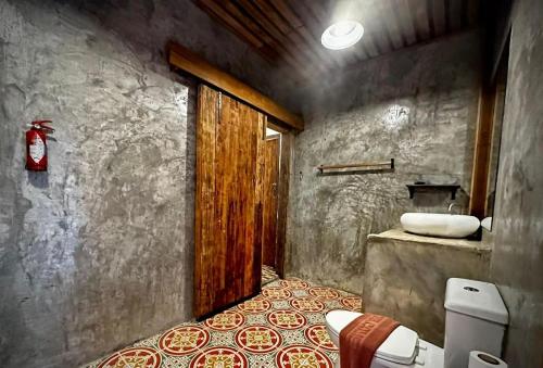 a bathroom with a bed and a sink in it at Sarita Resort Villa in Kampong Huaibū