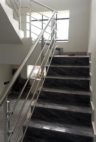 a staircase with metal railing in a building at Alpina Villa Hotel in Taba