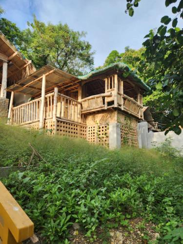 a wooden house sitting on top of a hill at Guarin House in Sipating