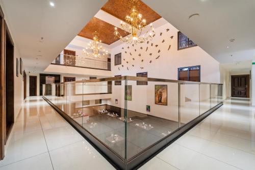 a glass floor in a building with a chandelier at Treebo Premium Silva Lux in Wayanad