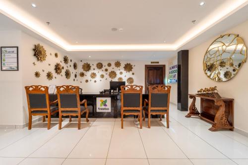 a dining room with chairs and a table at Treebo Premium Silva Lux in Wayanad
